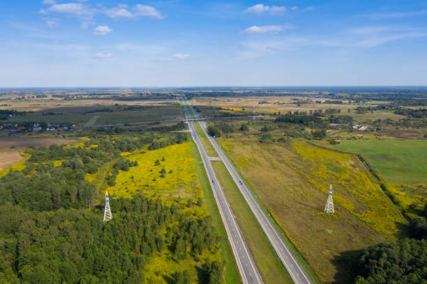 istock A long, straight two-lane highway that goes into the distance. 1212803032