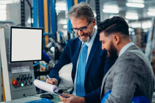 istock Engineers talking while inspecting machinery stock photo 1212803237