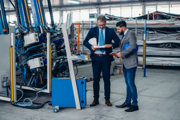 istock Engineers talking while inspecting machinery stock photo 1212803336