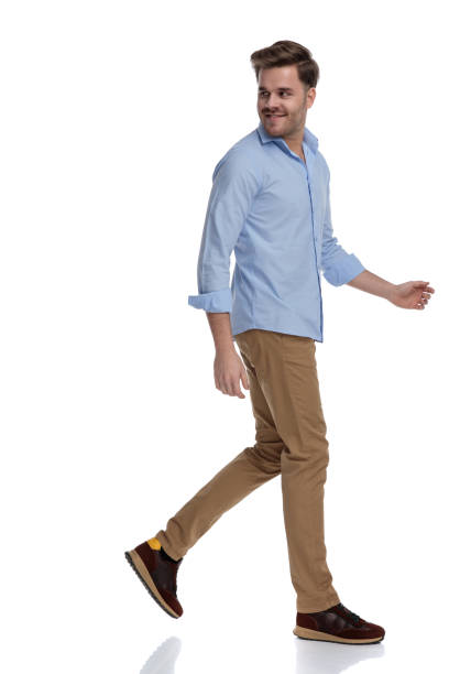 istock Side view of happy casual man looking over shoulder 1212804305