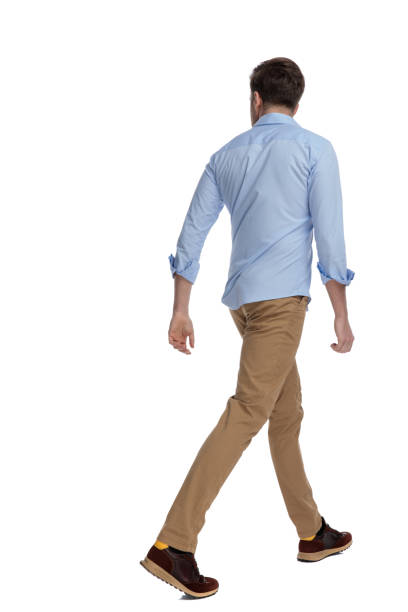 istock Side-rear view of casual man walking 1212804373