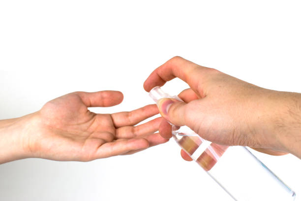 istock Anti-coronavirus spray. A man disinfects his hands. 1212806976