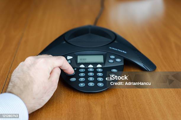 Businessman Dialing Conference Call Stock Photo - Download Image Now - Business Meeting, Conference Phone, 20-29 Years