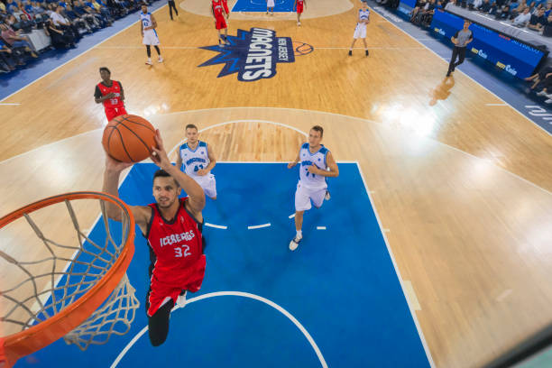 istock Basketball player slam dunking basketball 1212807597