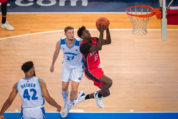 istock Basketball players playing on court 1212807609