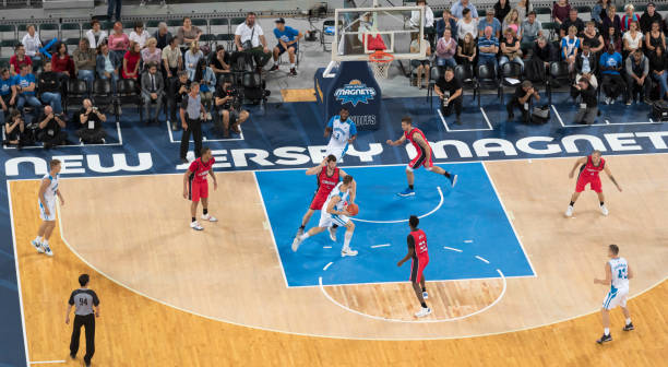 istock Basketball players tackling for ball 1212807610