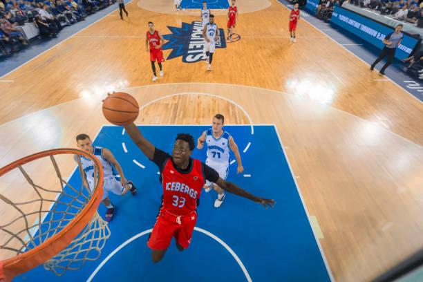 istock Basketball player slam dunking basketball 1212807623