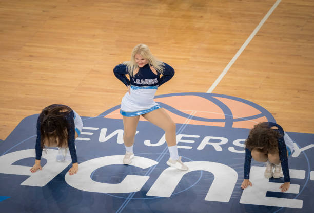 istock Cheerleader performing on basketball court 1212807624