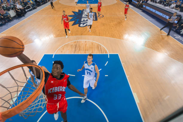 istock Basketball player slam dunking basketball 1212807630