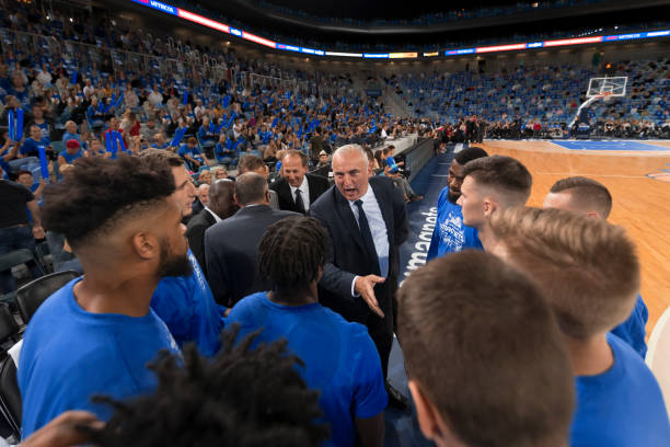 istock Basketball players shaking hands with coach 1212807635