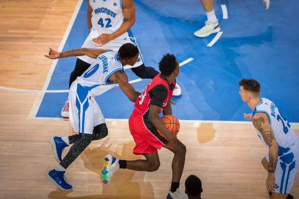 istock Basketball players tackling for ball 1212807646