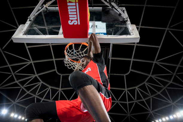 istock Basketball player hanging from hoop 1212807649