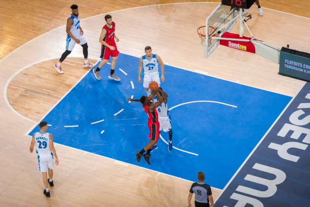 istock Basketball players playing on court 1212807652