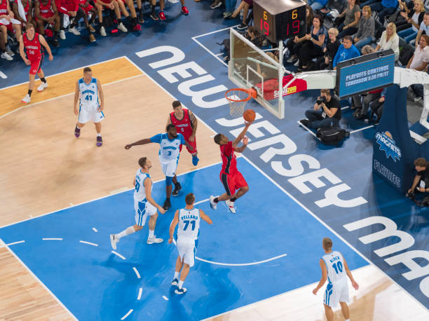 istock Basketball players playing on court 1212807653