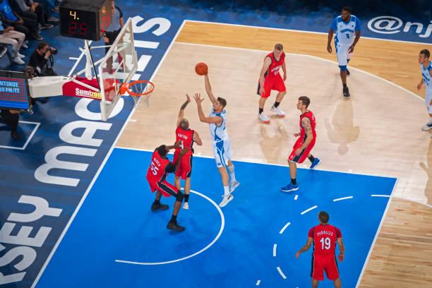 istock Basketball players playing on court 1212807655