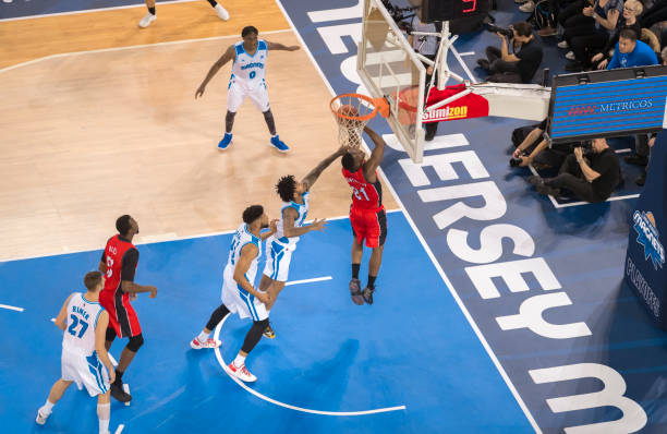 istock Basketball players playing on court 1212807658