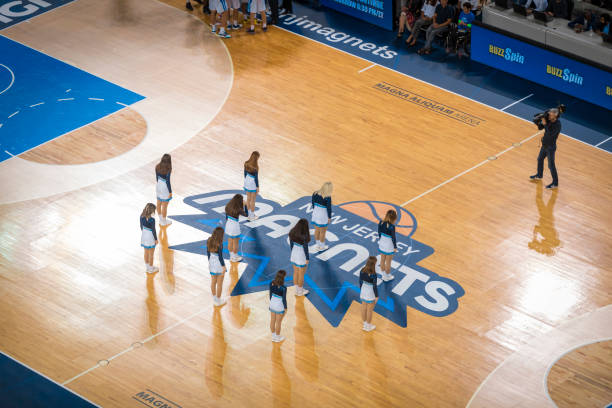 istock Cheerleader performing on basketball court 1212807664