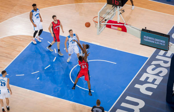 istock Basketball players playing on court 1212807673