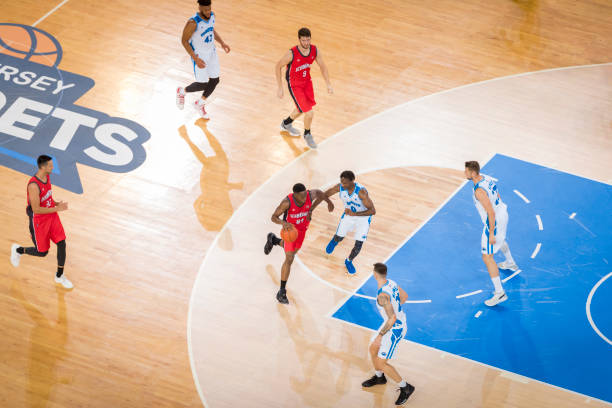istock Basketball players playing on court 1212807687