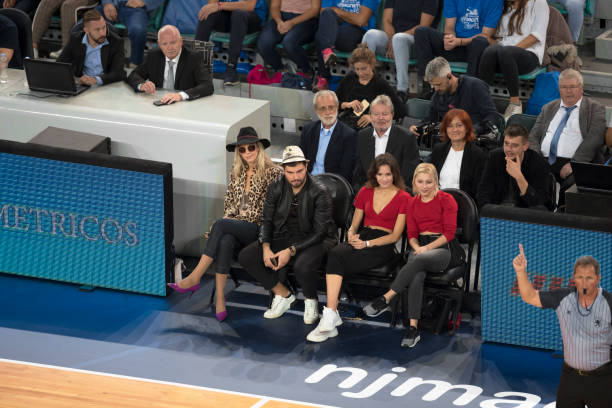 istock Celebrities watching basketball match 1212807691
