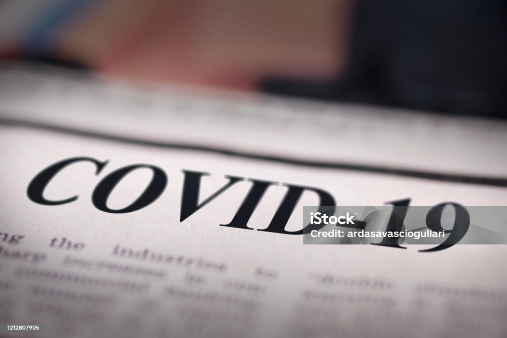 COVID-19 written newspaper COVID-19 written newspaper close up shot to the text. COVID-19 Stock Photo