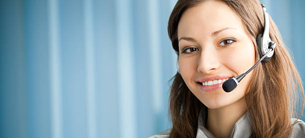 Portrait of smiling support phone operator in headset stock photo