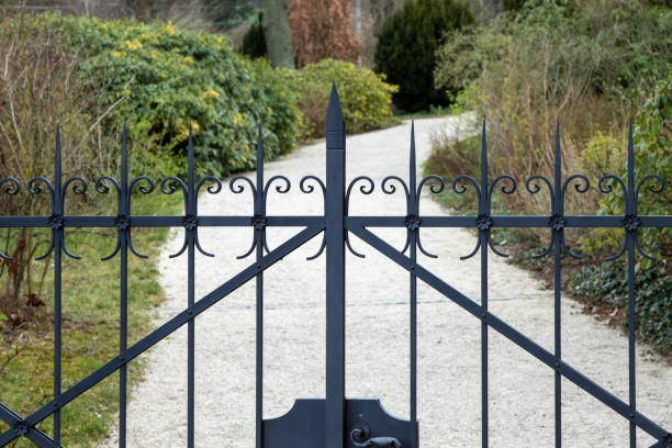 istock wrought iron gate as entrance to a beautiful garden 1212808701