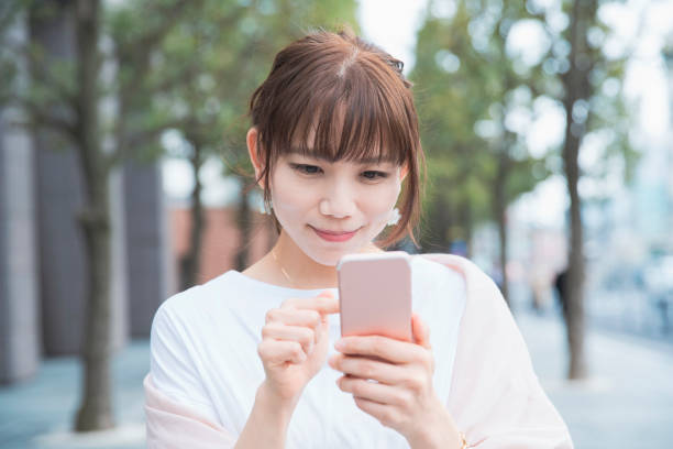 istock young woman using smart phone 1212809027