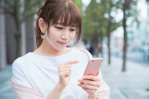 istock young woman using smart phone 1212809056