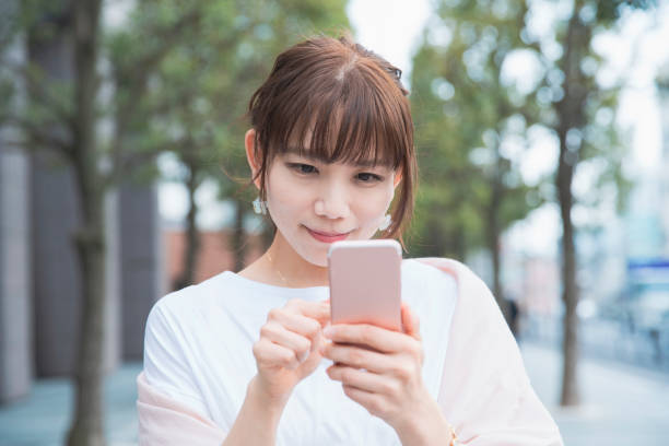 istock young woman using smart phone 1212809119