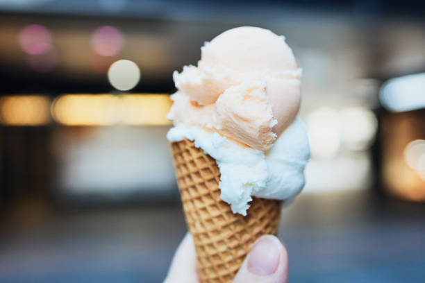 istock ice cream cone in a hand in a city center 1212809342