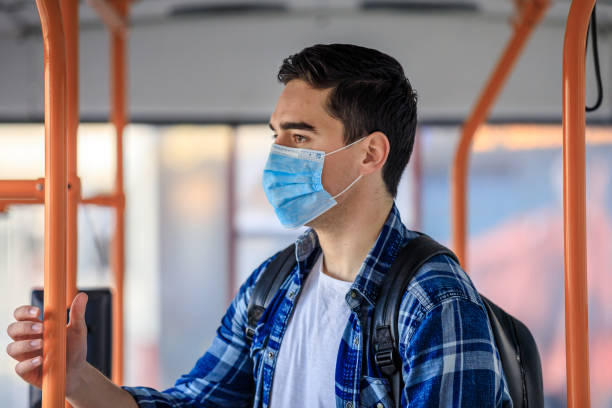 istock Men  in bus wearing face mask 1212809445