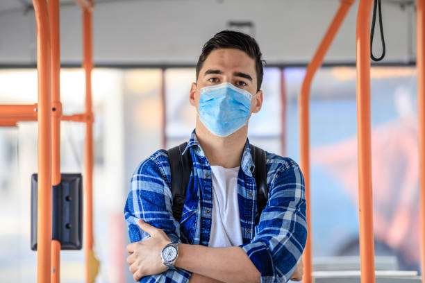 istock Men  in bus wearing face mask 1212809453