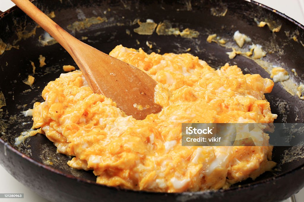 Closeup of cooking scrambled eggs in a pan  Scrambled Eggs Stock Photo