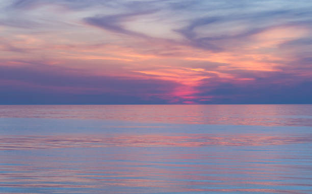 istock Twilight Dusk. Beautiful clouds over the calm sea. 1212810335