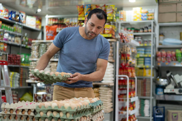 istock Healthy handsome man shopping for eggs at a small market 1212811024