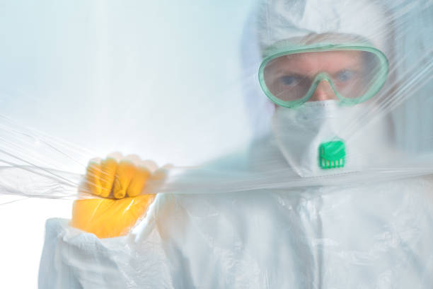 istock Worried exhausted epidemiologist trapped behind plastic curtain in virus quarantine 1212812137