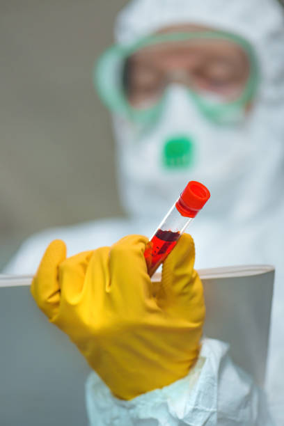 istock Virologist with blood test sample lab tube 1212812164