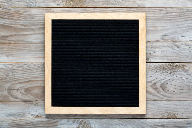 istock Empty black letterboard on wood background. Design mockup 1212812619
