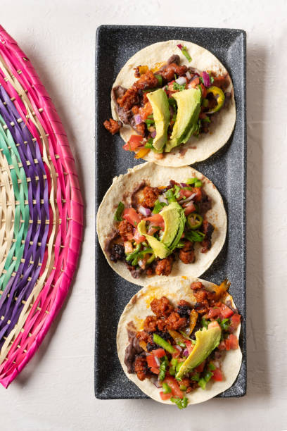 istock Mexican pork chorizo tacos with avocado and beans on white background 1212812791
