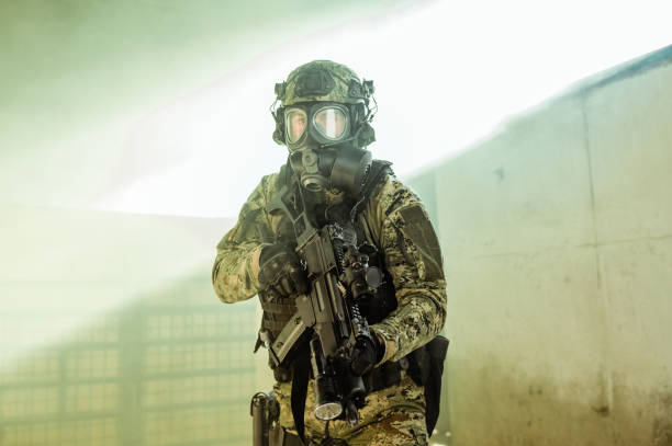 Soldier with gas mask Soldier in cropat uniform with protective gas mask M95 and assault rifle G36, caliber 5.56x45. gas mask stock pictures, royalty-free photos & images