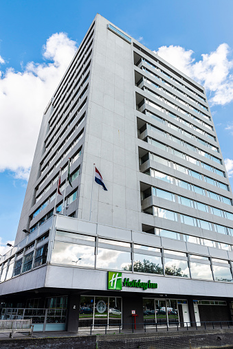 Amsterdam, Netherlands - September 7, 2018: Facade of the Holiday Inn hotel and Starbucks cafe in Amsterdam, Netherlands