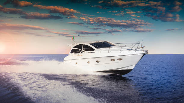 Luxurious motor boat Luxurious motor boat sailing the sea at sunset leisure boating stock pictures, royalty-free photos & images