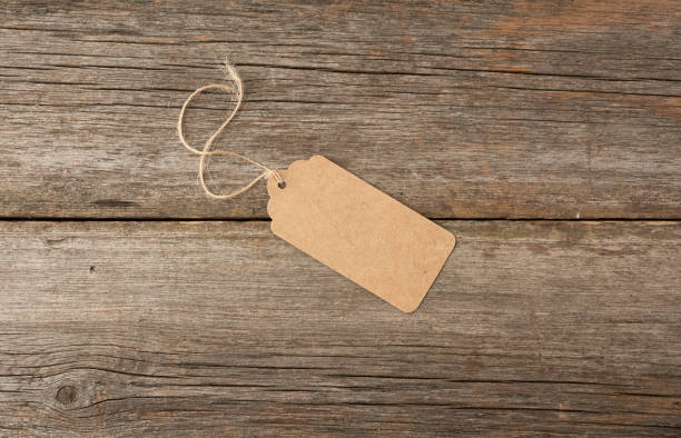 empty brown paper tag tied with white string. price, gift, sale tag - string package brown paper imagens e fotografias de stock