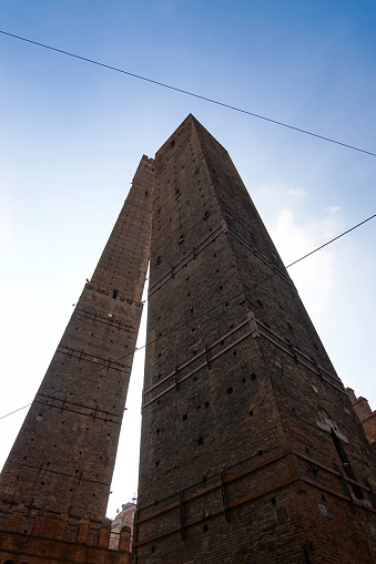 The Asinelli and the Garisenda are two leaning towers in Bologna. Bologna is the largest city of the Emilia-Romagna region.