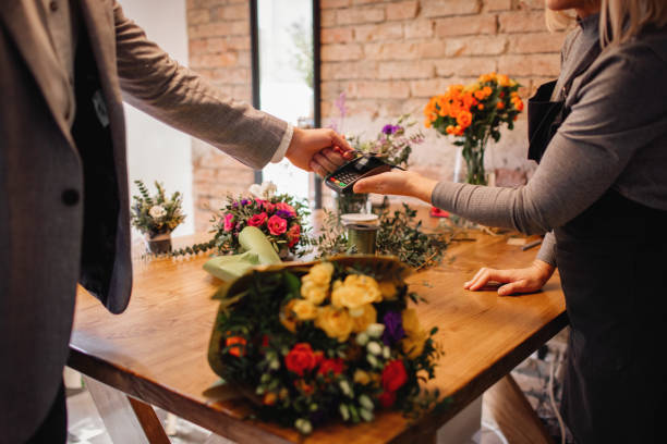 istock Customer Doing A Contactless Payment At Flower Shop 1212819740
