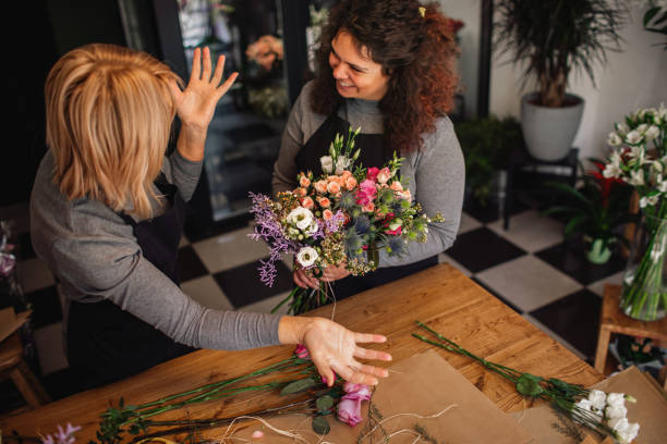 istock Female Florists Working In Flower Shop 1212819799
