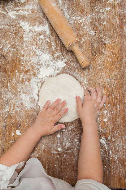 istock Young children make dough products. Hands closeup 1212819948