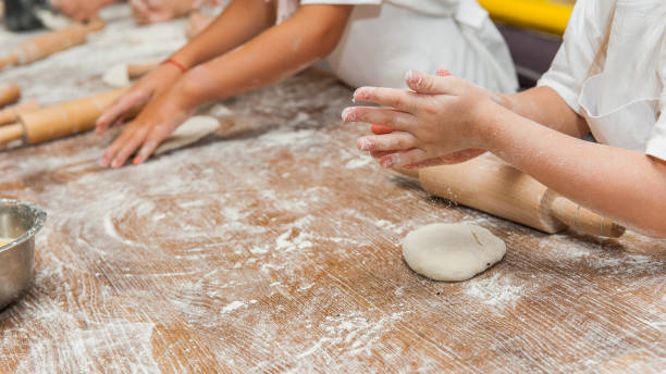 istock Young children make dough products. Hands closeup 1212819961