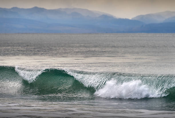 Rough sea under Cloudy sky in winter in La Marina beach in Alicante, Spain.
